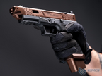 Hand holding a brown and black gun with a dark background