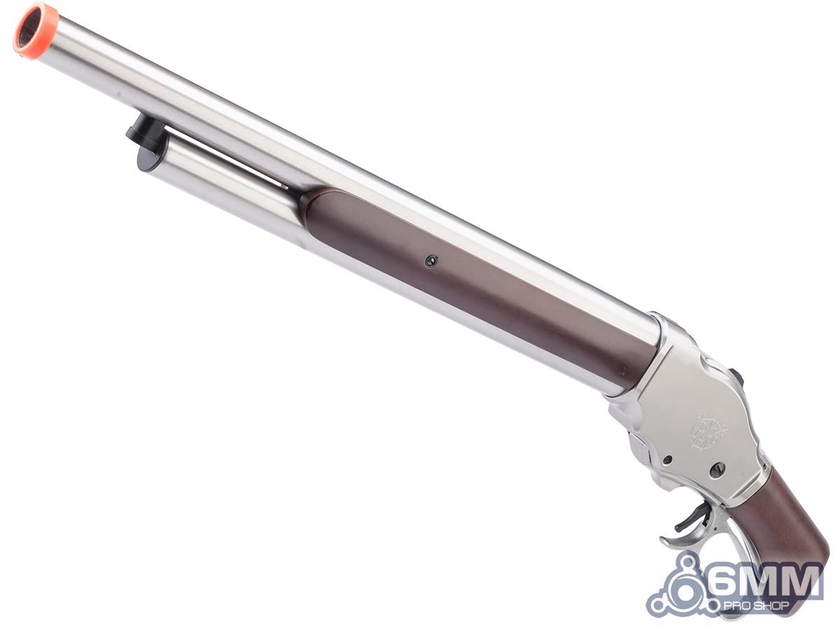 A replica or toy double-barrel shotgun with a polished silver metal finish, dark brown grip panels, and an orange safety tip on the muzzle, shown against a plain white background.