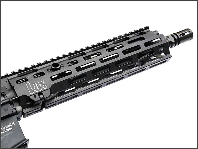 A close-up of a black tactical rifle handguard with a muzzle device, featuring the LVK logo on the side, set against a white background with an ACTION! store watermark.