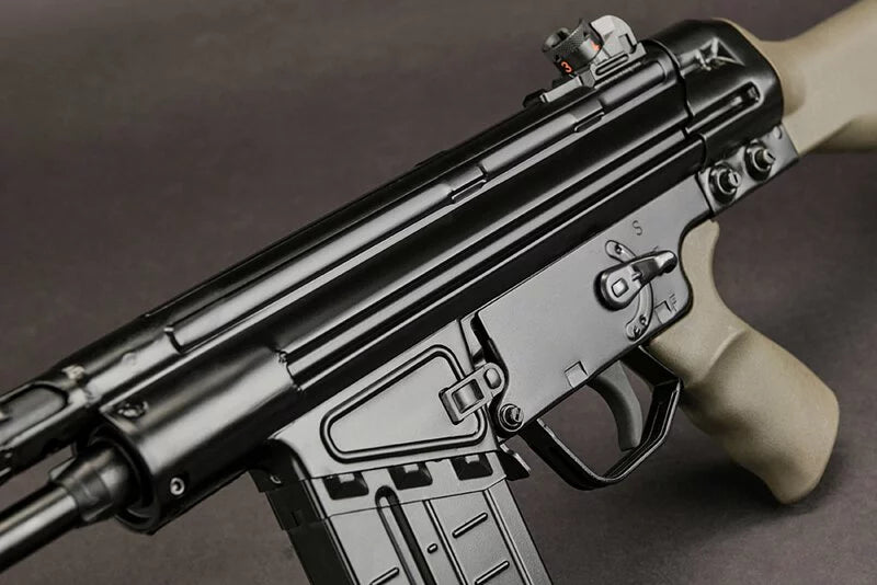 A close-up shot of a black tactical submachine gun with a tan/grey grip and stock, set against a dark grey background.
