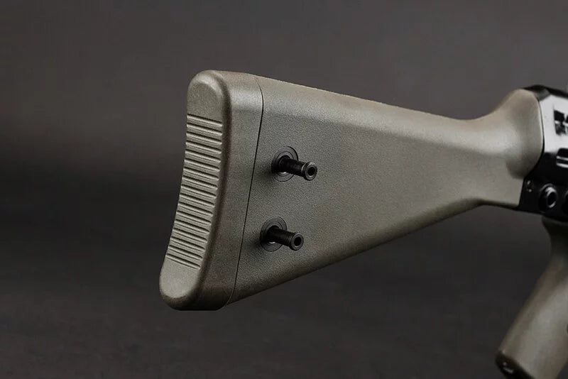 Close-up of a rifle stock with a textured rear butt pad and two black adjustment screws, shown against a dark gray background.