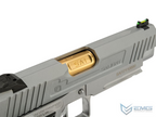 Close-up of a gray handgun with gold slide and EMG logo.