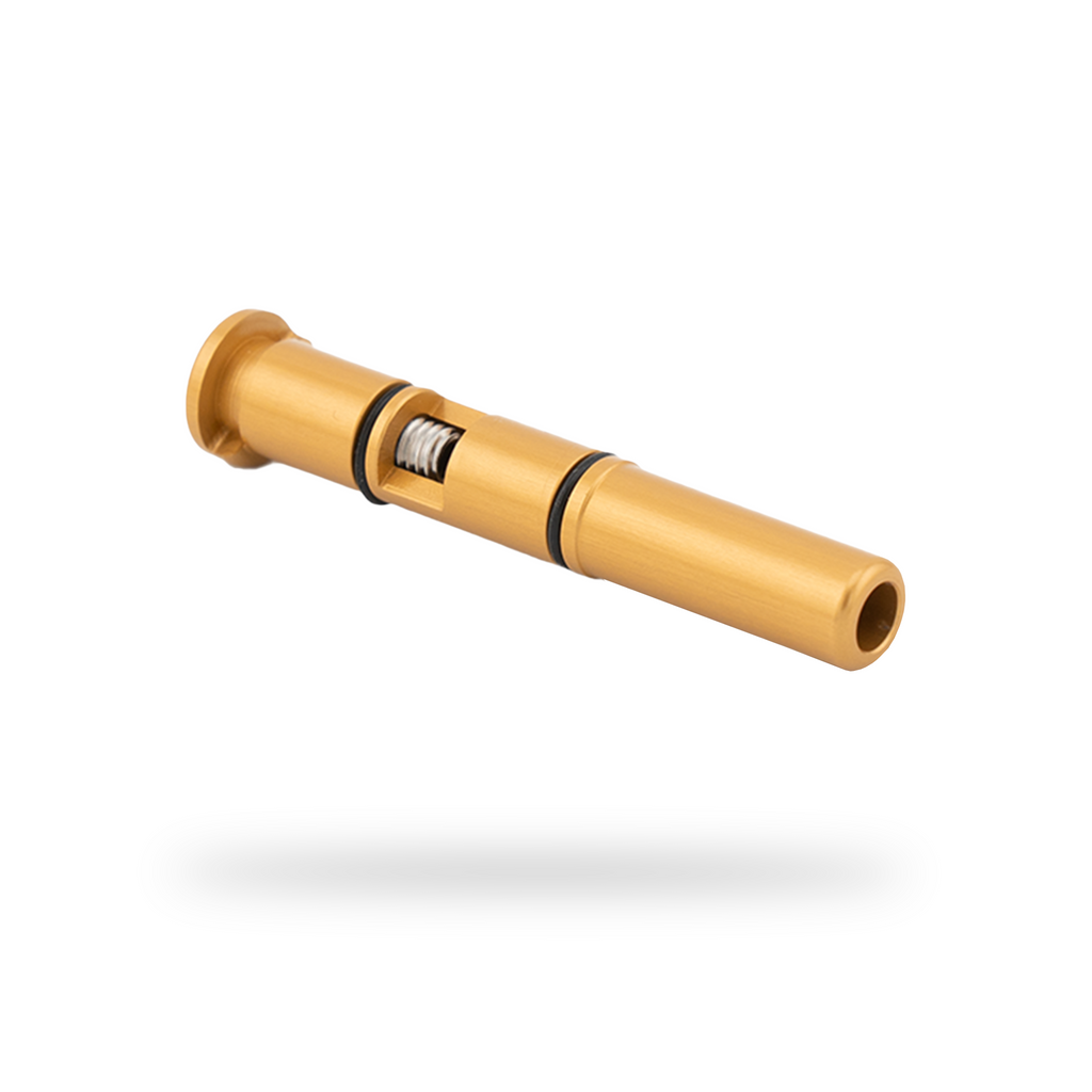 Gold-colored tool with a black band on a white background