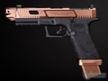 Tactical handgun with rose gold and black finish on a dark background