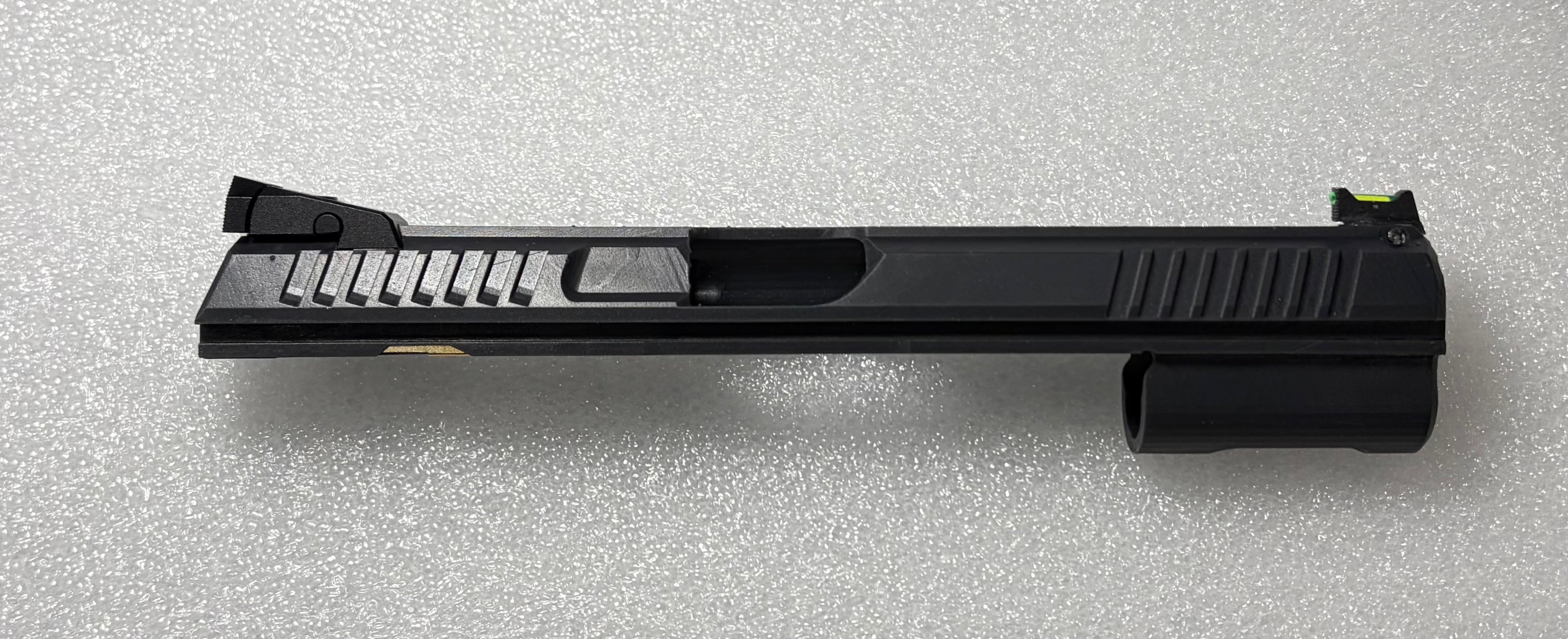 Black gun slide on a gray textured background