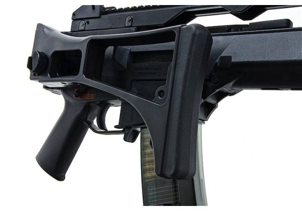 Close-up of a black tactical firearm accessory or stock assembly attached to a rifle, shown against a plain white background.