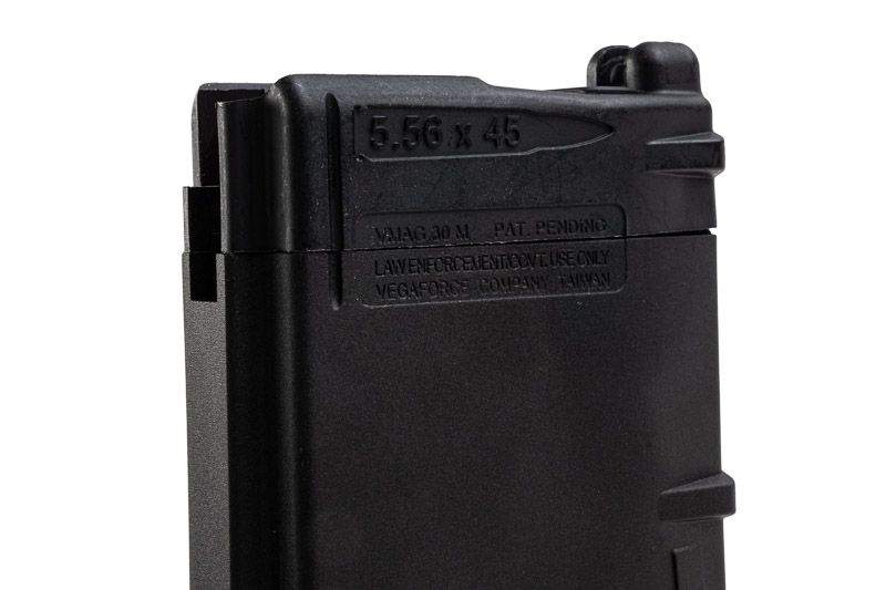 Black VFC VMAG V4 airsoft gas magazine side close-up showing moulded markings and feed lips.