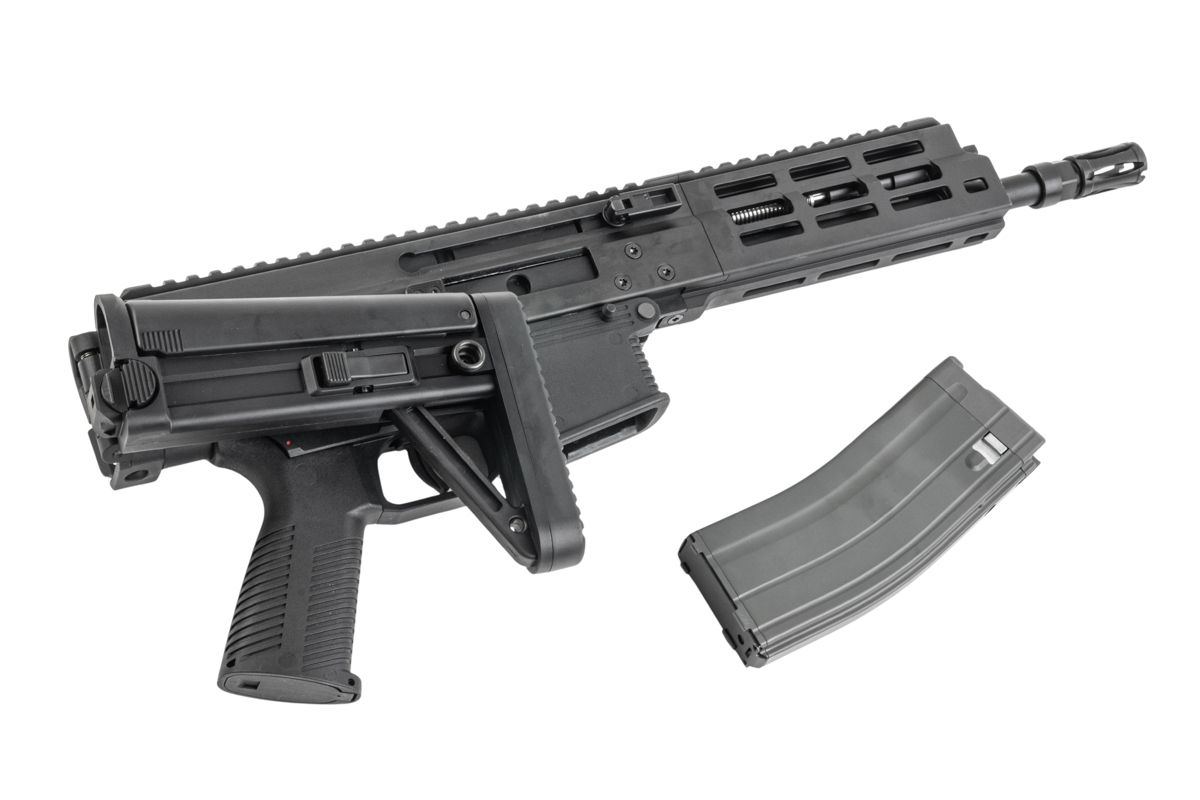 Maruyama/VFC ISO556 airsoft rifle with stock folded alongside the receiver and detached grey gas magazine.