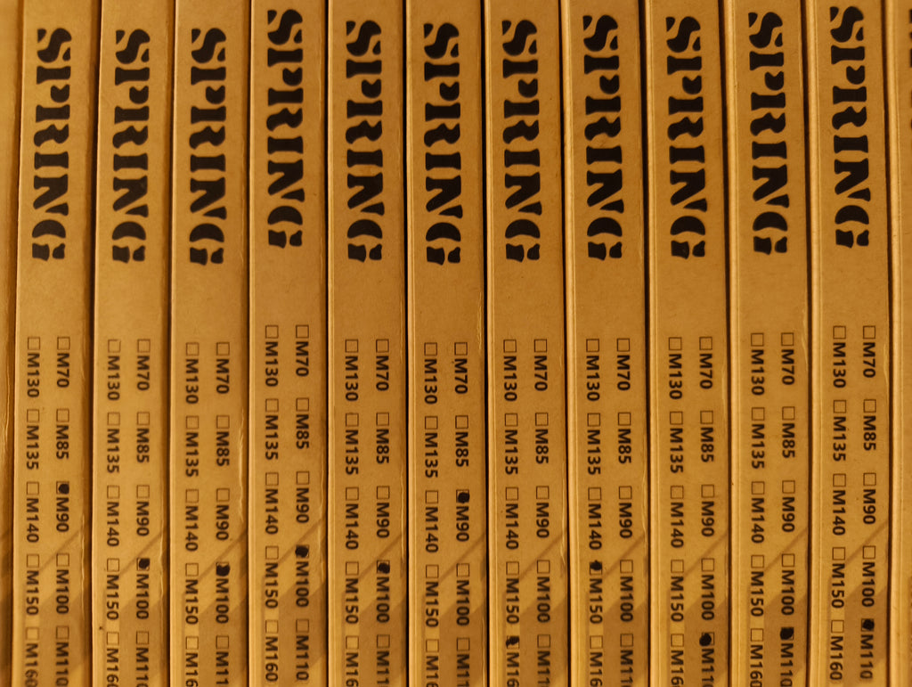 Row of wooden boxes labeled 'SPRING' with text and checkboxes.