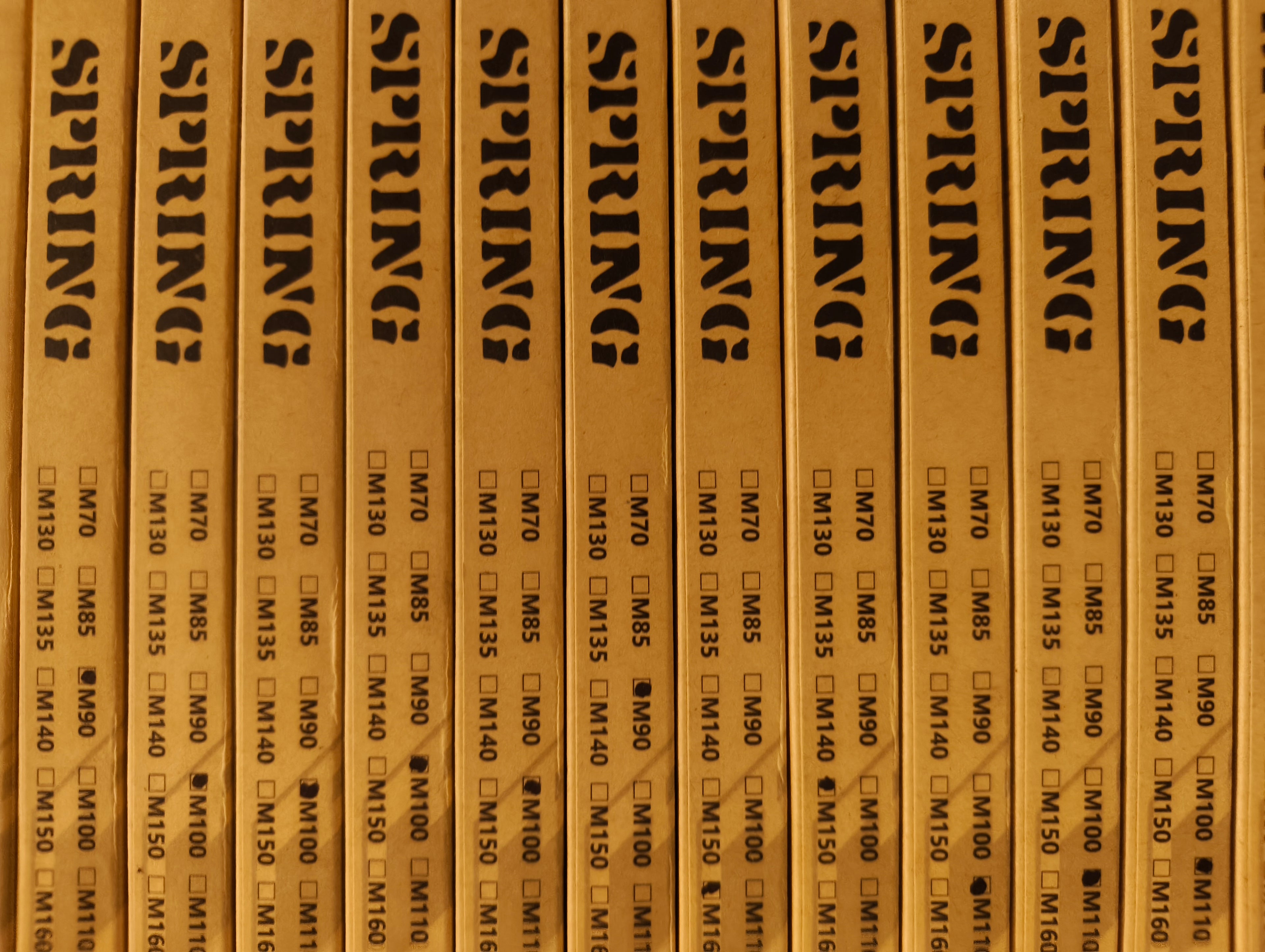 Row of wooden boxes labeled 'SPRING' with text and checkboxes.