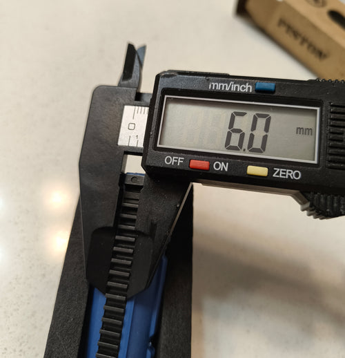 Digital caliper measuring a width of 60mm on a light gray background
