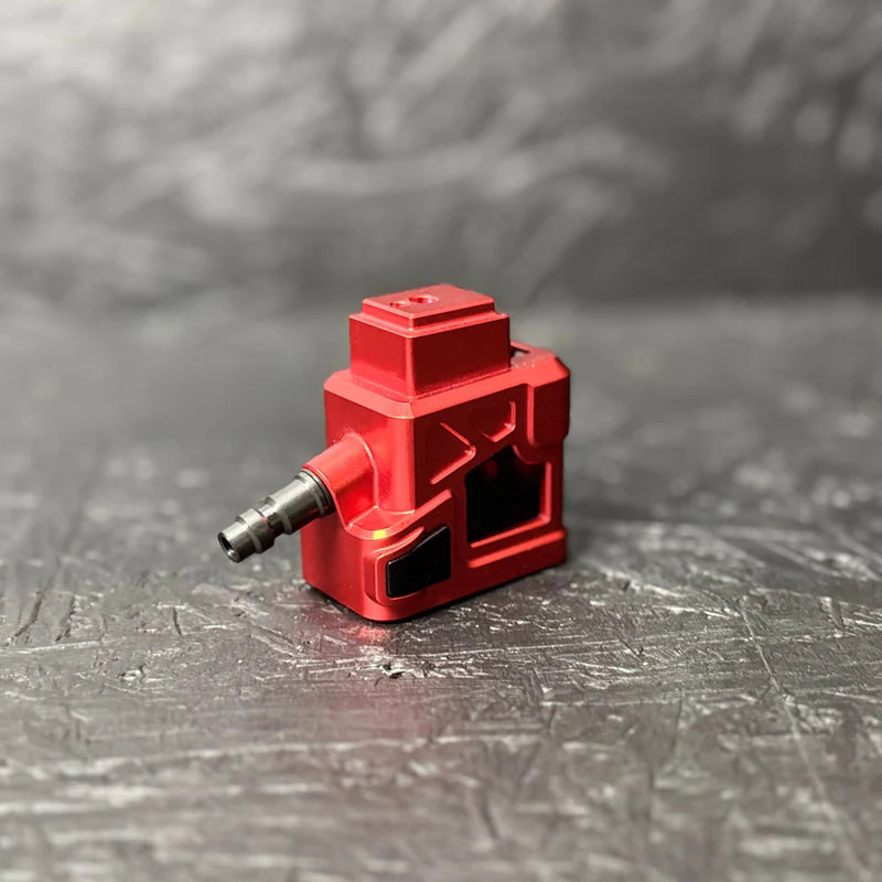 Red tool attachment on a textured gray surface