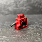 Red tool attachment on a textured gray surface