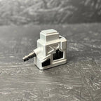Small mechanical component on a textured gray surface
