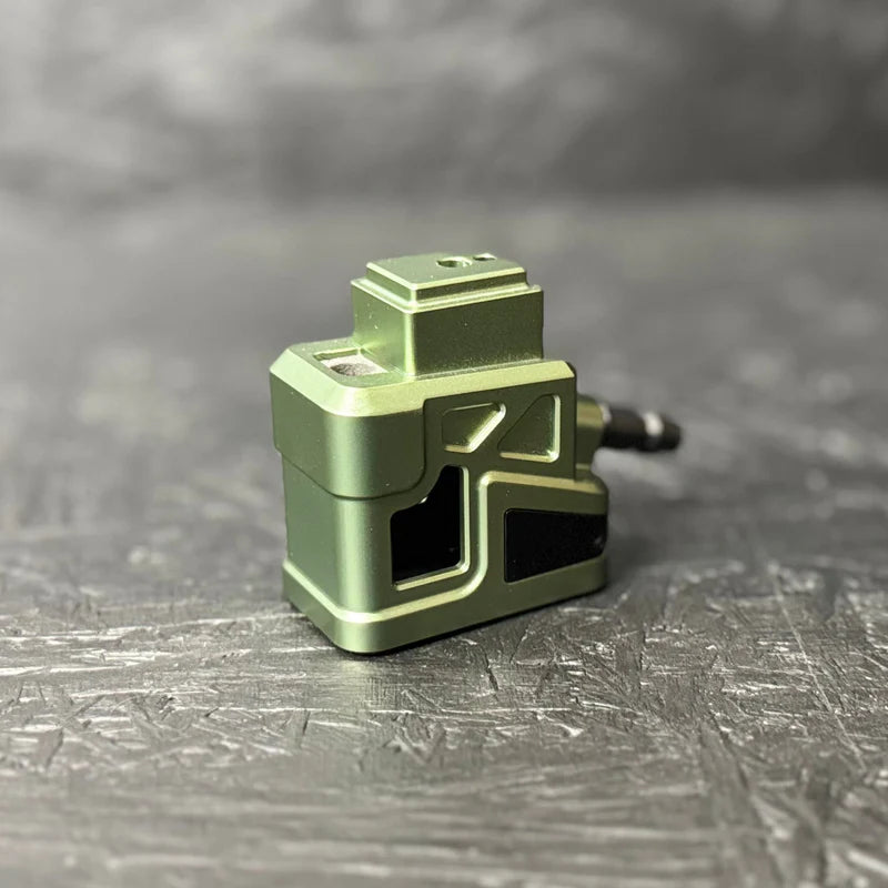 Green metal component on a textured gray surface