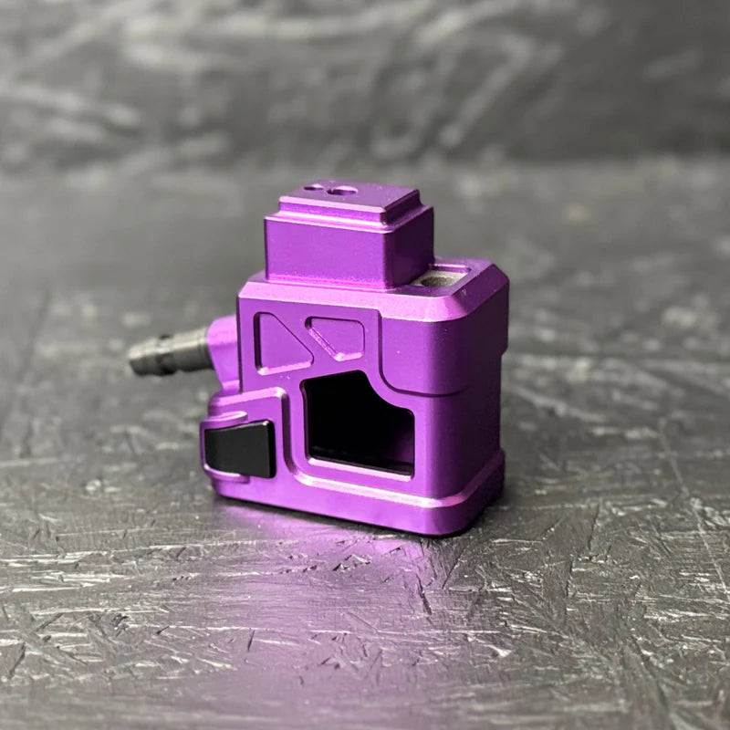 Purple mechanical component on a textured gray surface