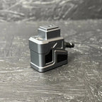 Small mechanical device on a textured gray surface