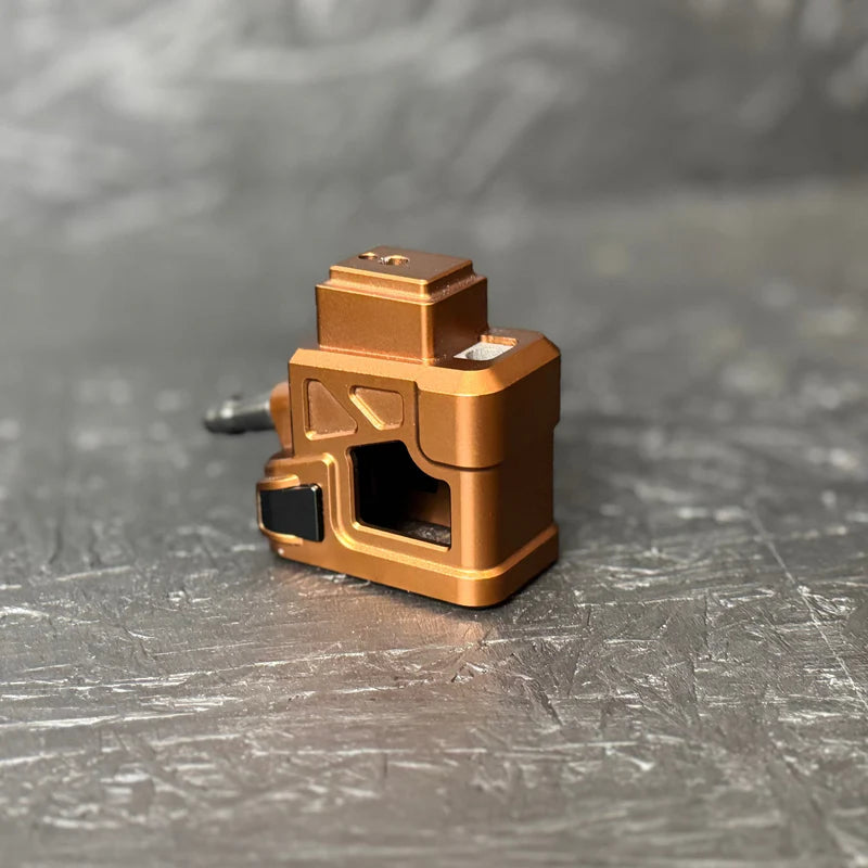 Bronze-colored metal component on a textured gray surface
