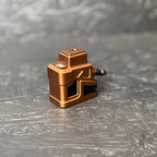 Bronze-colored mechanical component on a gray textured surface