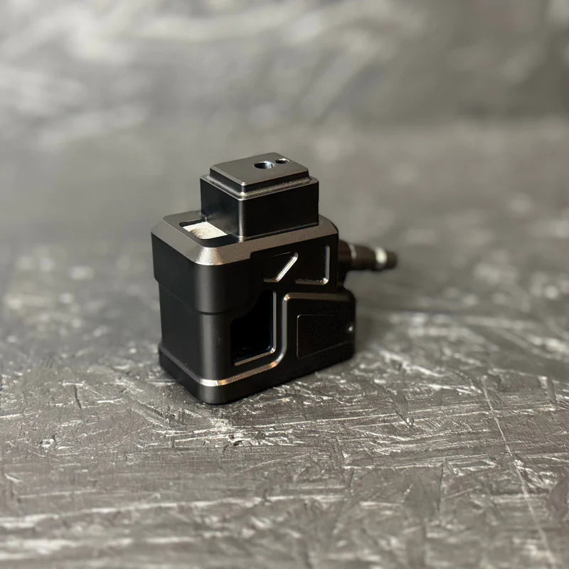 Black metal component on a textured gray surface