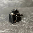 Black metal component on a textured gray surface