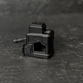 Black mechanical component on a textured black surface