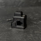 Black mechanical component on a textured black surface