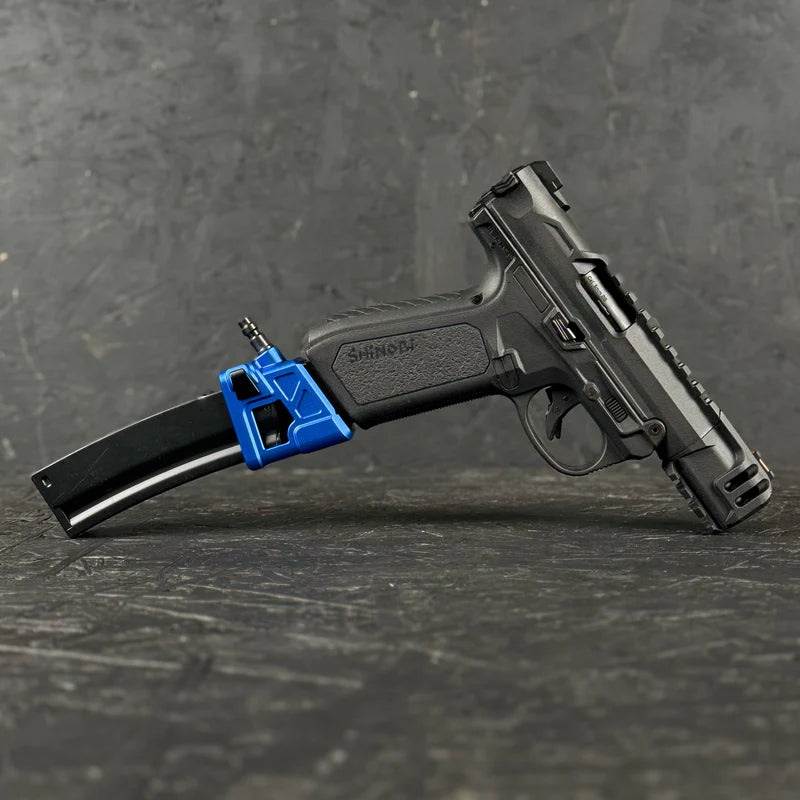 Black handgun with a blue magazine on a dark textured surface
