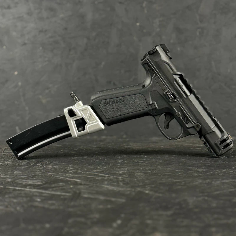 Black handgun with a magazine on a dark textured surface