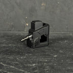 Black mechanical component on a textured black surface