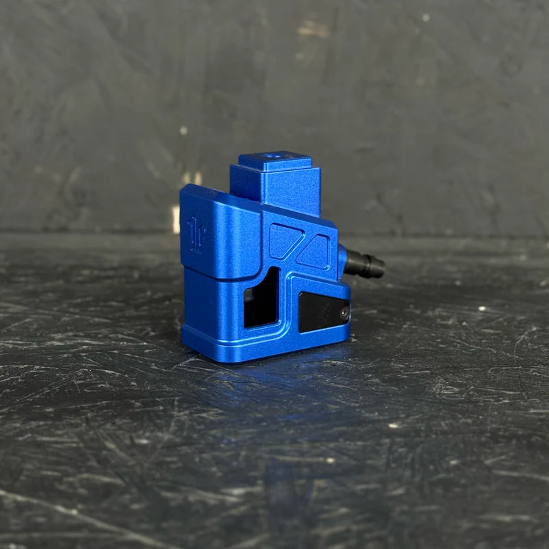 Blue mechanical component on a dark textured surface
