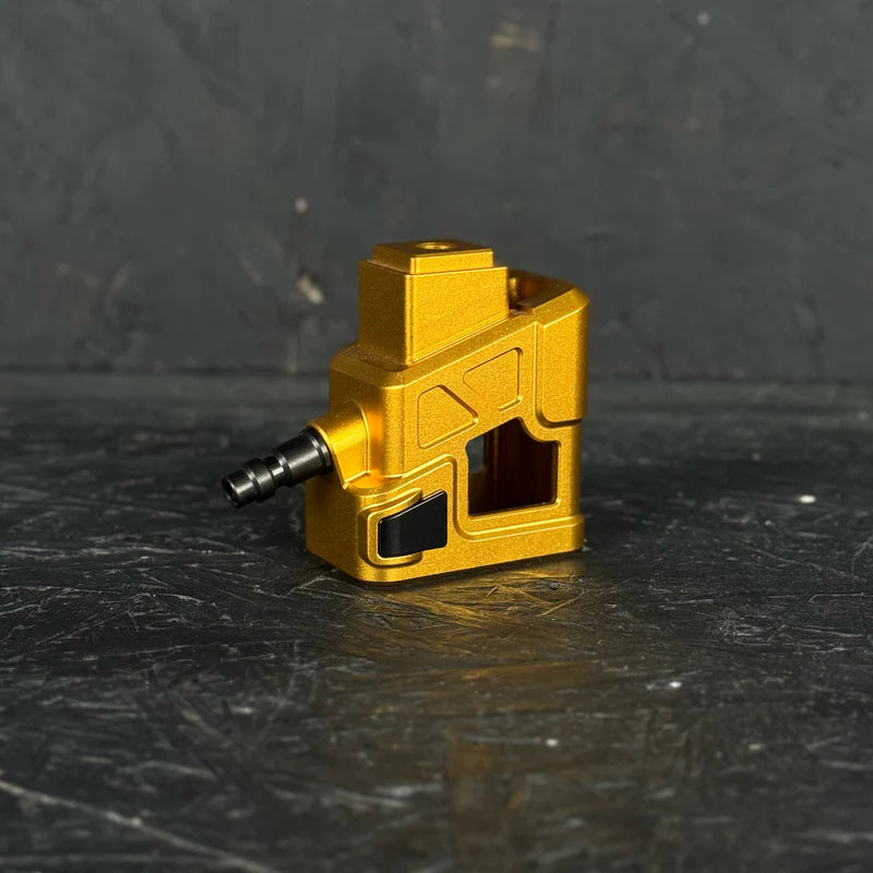 Gold metal component on a dark textured surface