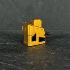 Gold metal component on a dark textured surface