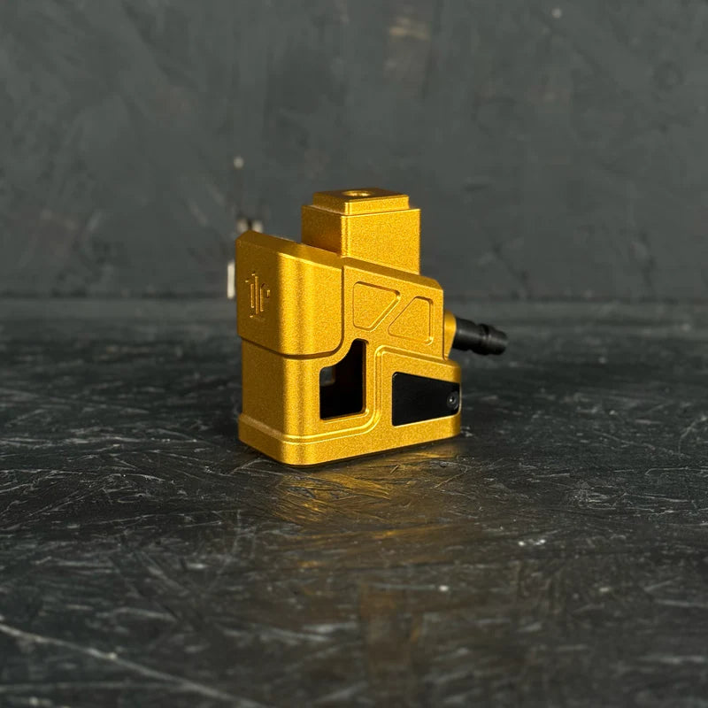 Gold metal component on a dark textured surface