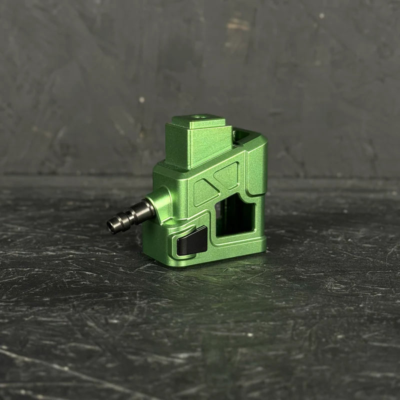 Green mechanical component on a dark textured surface