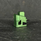 Green mechanical component on a dark textured surface