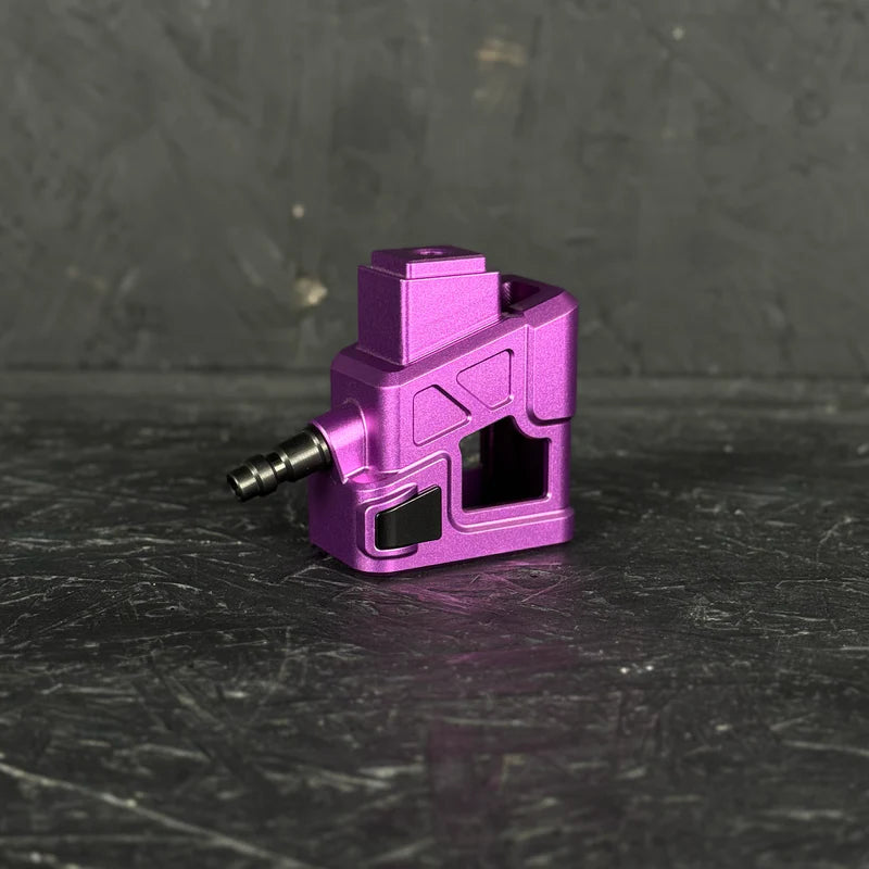 Purple metal component on a dark textured surface
