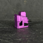 Purple metal component on a black textured surface