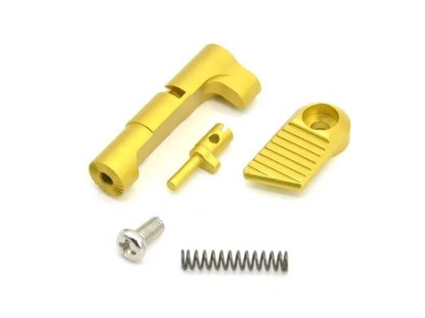 Yellow metal components including a spring, screw, and cylindrical part on a white background