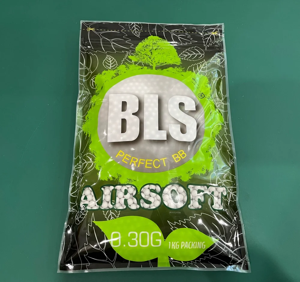 Packaging of BLS airsoft BBs on a green background
