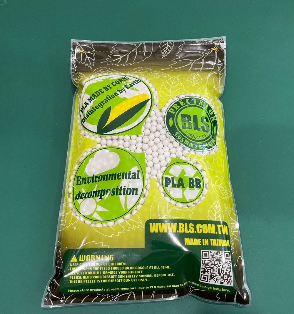 Bag of BLS environmental decomposition pellets with branding and product details on a green background