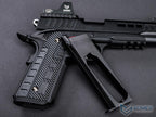 Black firearm with textured grip on a gray background, featuring EMG branding.