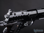 Close-up of a black revolver with visible branding on a dark background