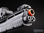 Close-up of a gun with an orange tip on a black background, featuring the EMG logo.