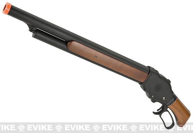 A replica or toy shotgun with a black metal barrel and receiver, brown faux wood grip and forend, and an orange safety tip, shown on a white background with a repeating EviKE watermark.