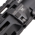 Close-up of a black tactical firearm accessory with a slide switch labeled CLOSE and IP.MAGPUL.