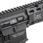 Close-up of a black Heckler & Koch rifle receiver and handguard with white logo and text on a white background.
